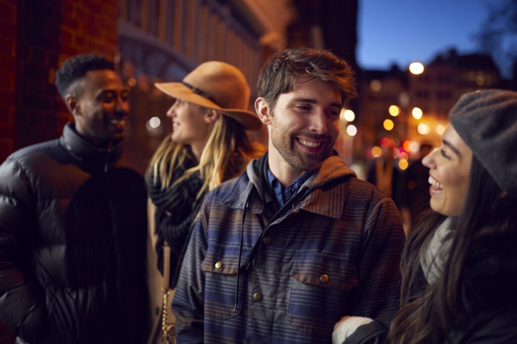 Group Of Friends In City Outdoors On Night Out Together