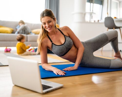 Young woman is exercising yoga at home. Fitness, workout, healthy living and diet concept